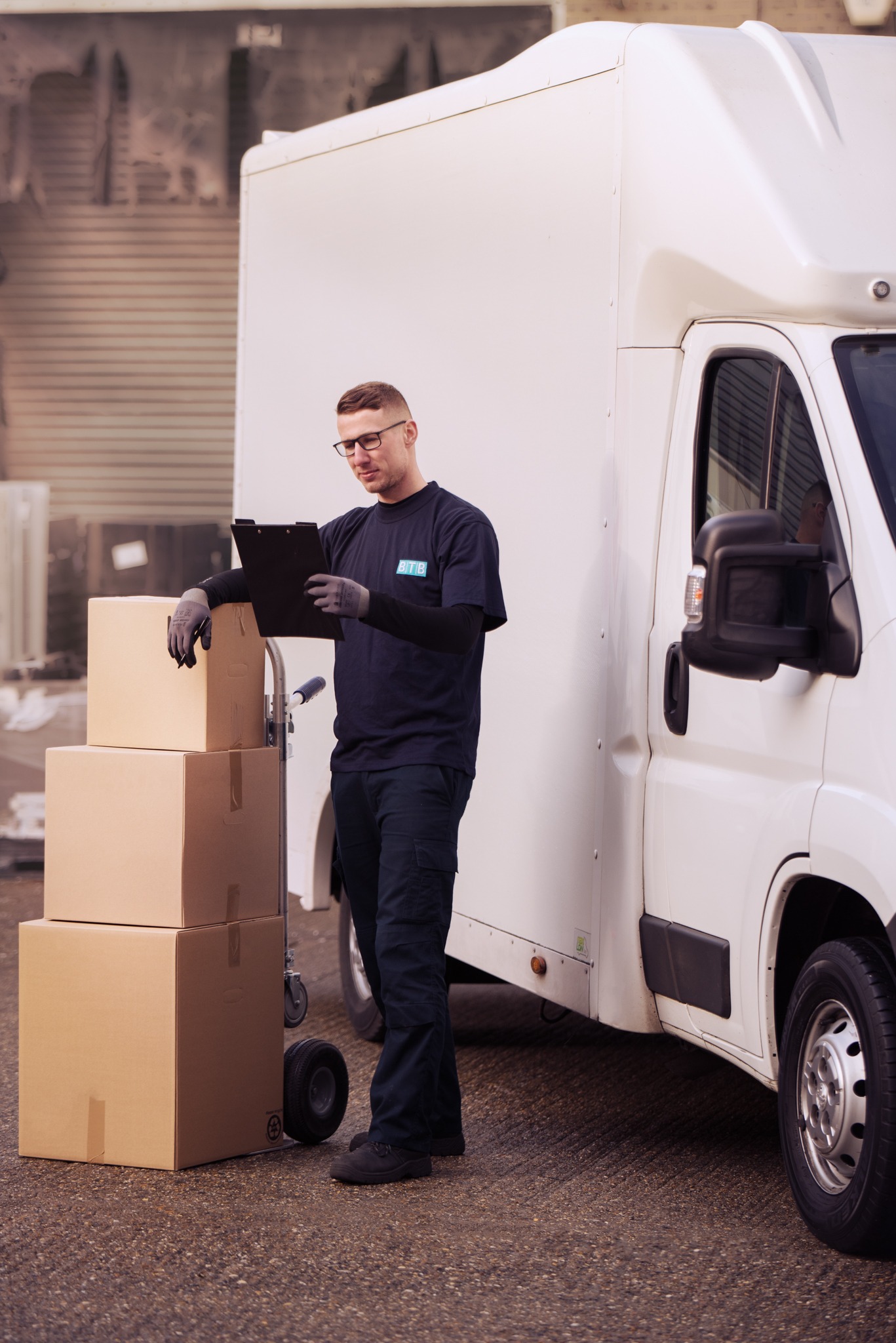 BTB team member preparing a delivery beside a Luton vehicle